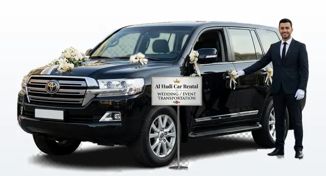 Black Land Cruiser decorated with white flowers and a chauffeur beside an Al Hadi wedding and event transportation sign
